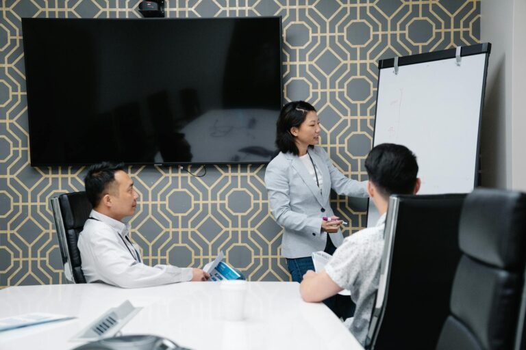 A professional conducting a presentation in a modern office space with colleagues engaged.
